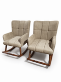 Two upholstered rocking chairs with high tufted backs, padded seats, and dark wood rockers, shown on a clean white studio background.