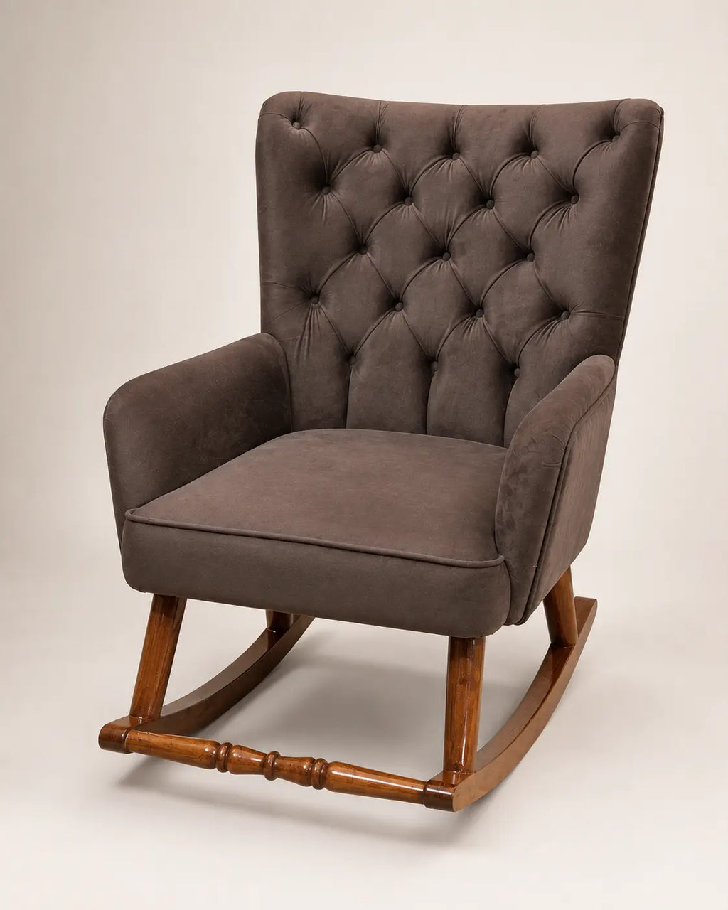 A classic wingback armchair with a tufted button-back high backrest, upholstered in a textured brown fabric, supported by a warm brown wooden rocking base.