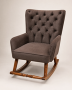 A classic wingback armchair with a tufted button-back high backrest, upholstered in a textured brown fabric, supported by a warm brown wooden rocking base.