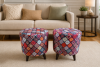 Two round upholstered ottomans with colorful patchwork diamond patterns and dark tapered legs, placed in front of a beige sofa in a living room setting.