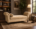 A classic tufted chaise lounge chaise lounge chaise lounge chaise lounge in a warm beige velvet fabric, styled in a cozy, traditional living room setting with a patterned rug, bookshelves, and a floor lamp.