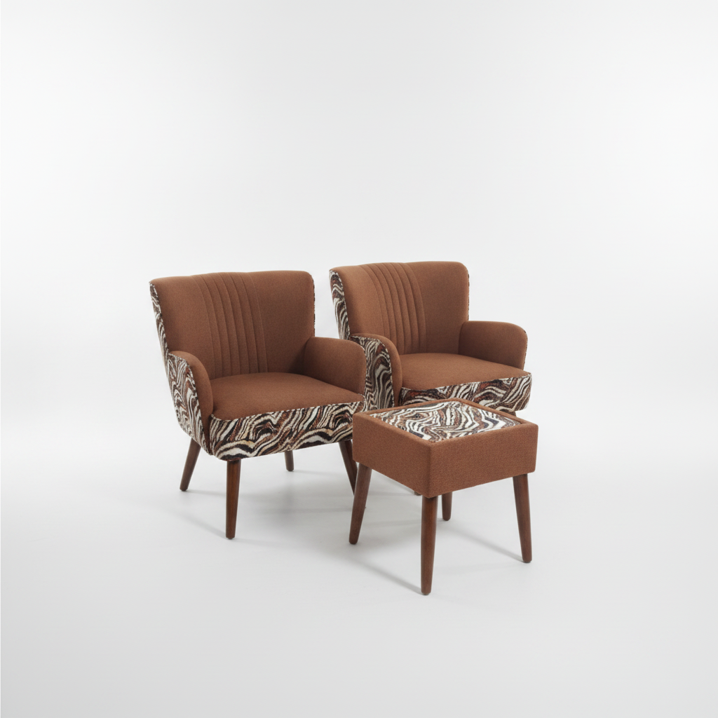 A pair of mid-century modern armchairs with matching ottoman, upholstered in rust brown fabric with zebra-patterned armrests and dark wood legs, photographed on a seamless white studio background.